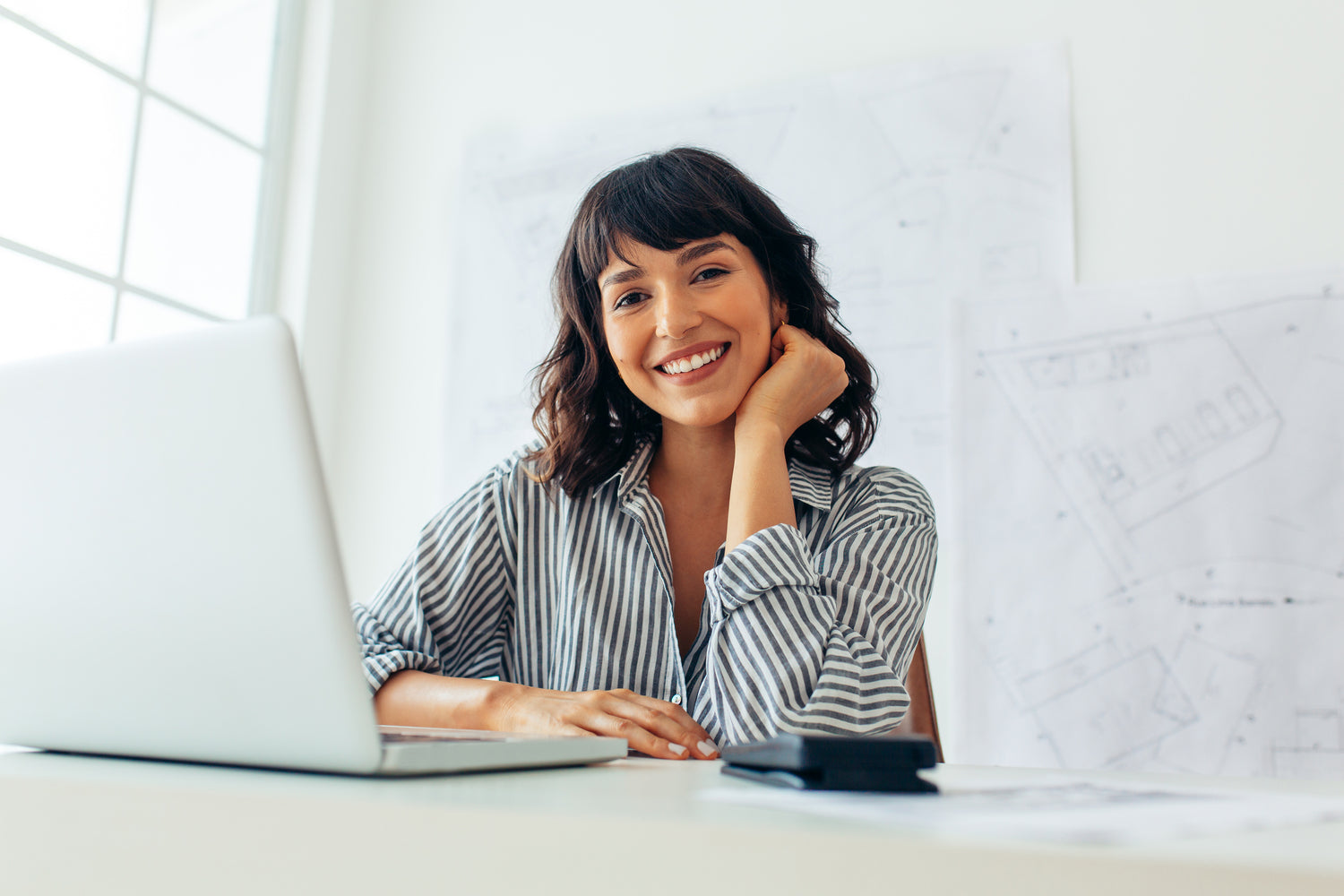 Woman in front of her computer sitting at her desk